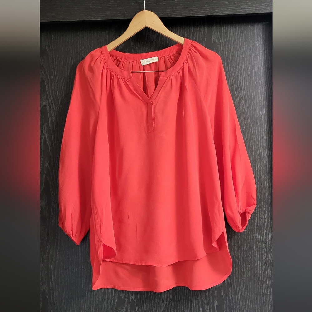 Women's Coral Blouse women's coral-colored blouse with a v- neck, three-quarter